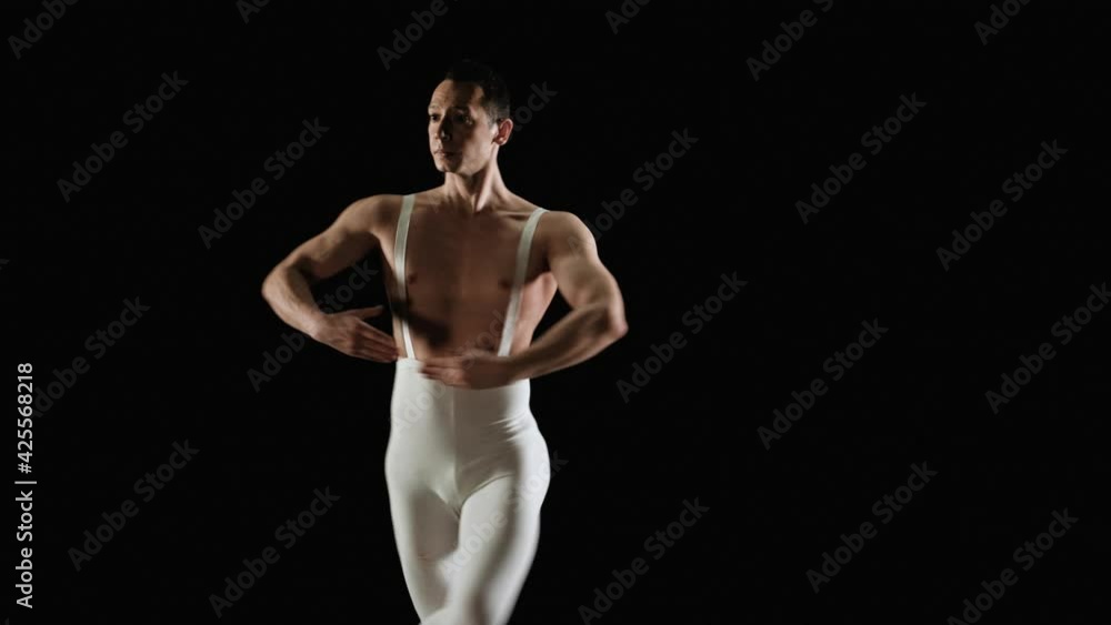 Ballet dancer performs dance on a black background. Slow motion Ballet dancer performs dance on a black background. Slow motion