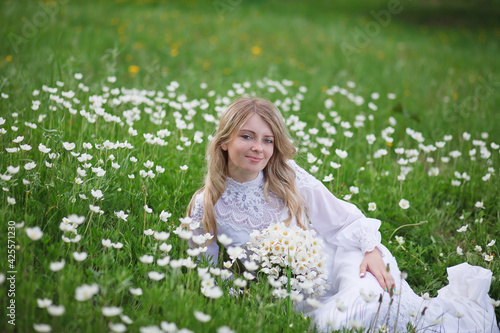 beautiful girl, a blonde in a vintage white dress walks in a blooming apple orchard, a bouquet of anemones, a bride