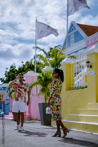 Curacao, colorful bouldings around Willemstad Punda and Otrobanda Pietermaai district, multicolored homes in Pietermaai Curacao Caribean Island , couple men and woman on vacation Curacao photo