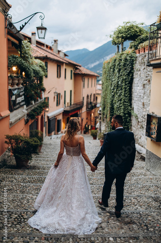 The bride and groom travel through the old Italian city.