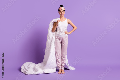 Full length body size photo of girl keeping blanket smiling wearing pajama sleeping mask isolated pastel violet color background