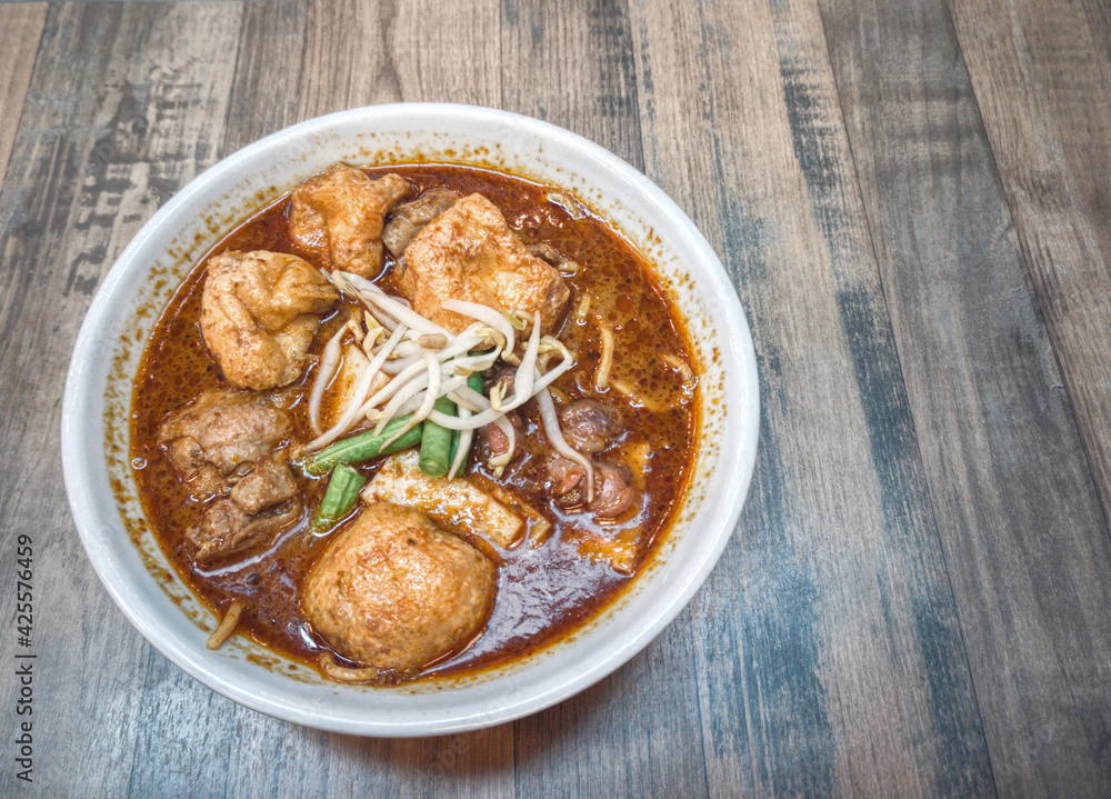 A serving of delicious curry noodles, one of Malaysia famous dishes. Selective focus points. A serving of delicious curry noodles, one of Malaysia famous dishes. Selective focus points.