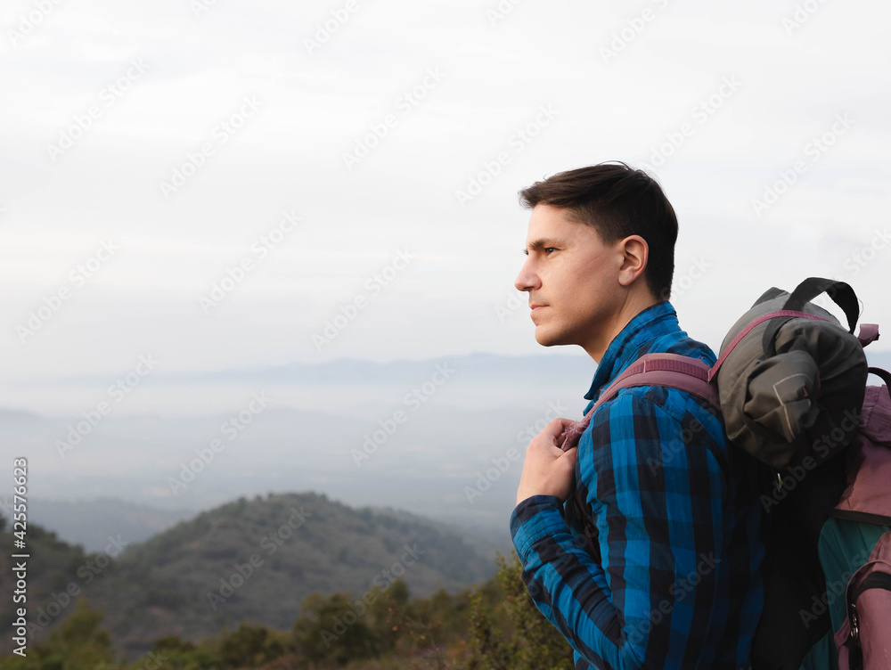 young man with backpack in the mountain