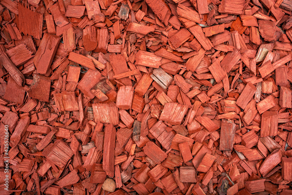 Colored wood chips for landscape design. red mulch, view from above