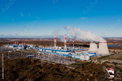 Ecology and environmental pollution. Smoking chimneys of plant, coal power plant.