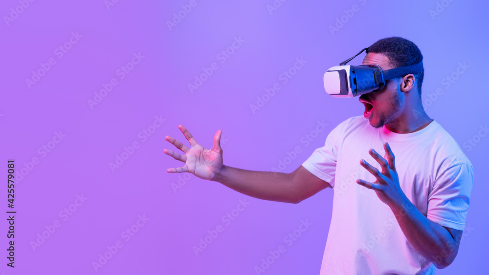 Virtual Gaming Concept. Portrait Of Excited Black Male Enjoying Augmented Reality Experience Virtual Gaming Concept. Portrait Of Excited Black Male Enjoying Augmented Reality Experience