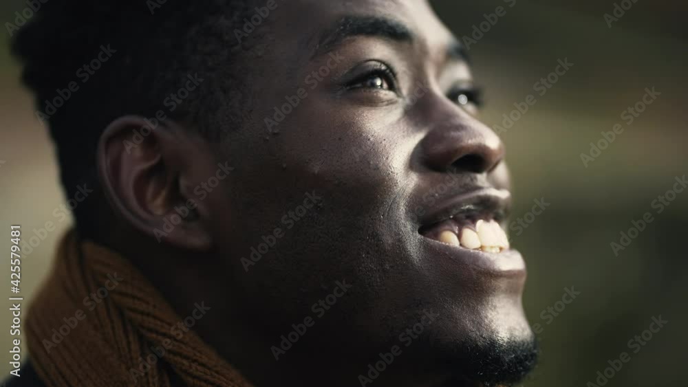 Hopeful black African man close-up face joyful emotion Hopeful black African man close-up face joyful emotion