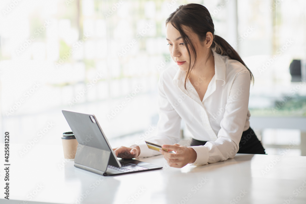 Portrait of Young woman using credit card and tablet for buying online shopping at home ,payment,buying and online shopping concept. Portrait of Young woman using credit card and tablet for buying online shopping at home ,payment,buying and online shopping concept.