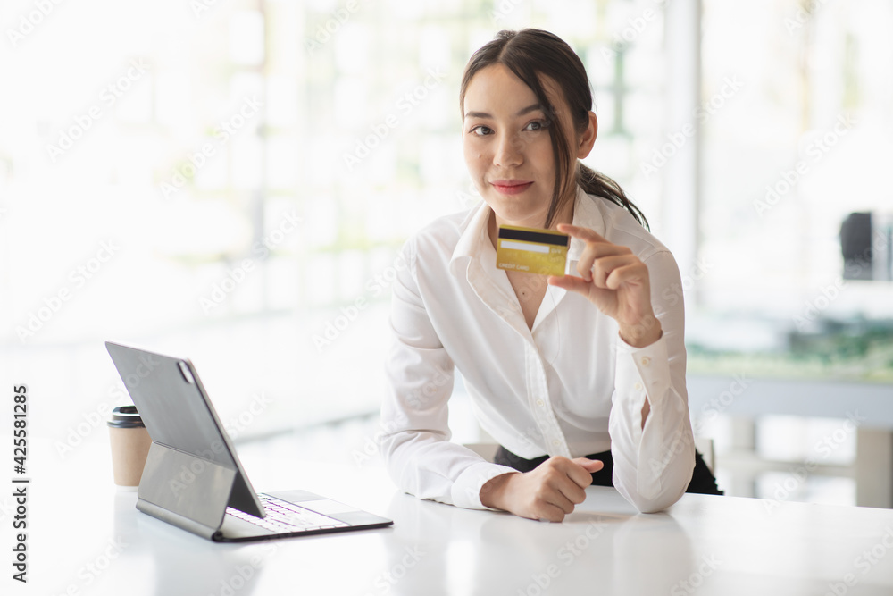 Portrait of Young woman using credit card and tablet for buying online shopping at home ,payment,buying and online shopping concept. Portrait of Young woman using credit card and tablet for buying online shopping at home ,payment,buying and online shopping concept.
