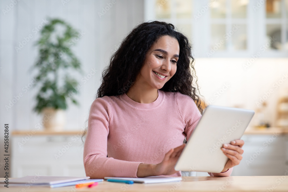 Distance Learning. Happy Young Woman Study With Digital Tablet In Kitchen Distance Learning. Happy Young Woman Study With Digital Tablet In Kitchen