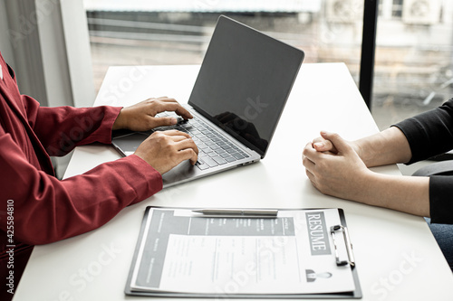 The HR department is typing a laptop to fill out the applicant's information after being interviewed by the department manager and accepting jobs for the job applicant. Job application ideas