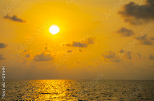 Beautiful golden sunlight on the sea and little cloud