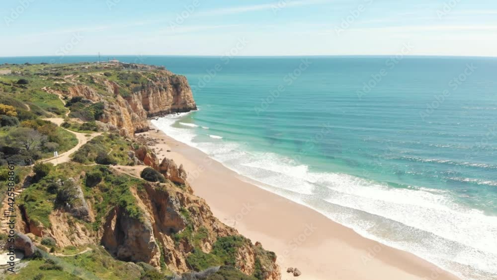 Canavial Beach seafront on the Algarve Golden Coast idyllic Landscape, Portugal - Aerial Panoramic Orbit shot Canavial Beach seafront on the Algarve Golden Coast idyllic Landscape, Portugal - Aerial Panoramic Orbit shot