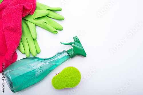 green gloves, window cleaner, and a pink rag