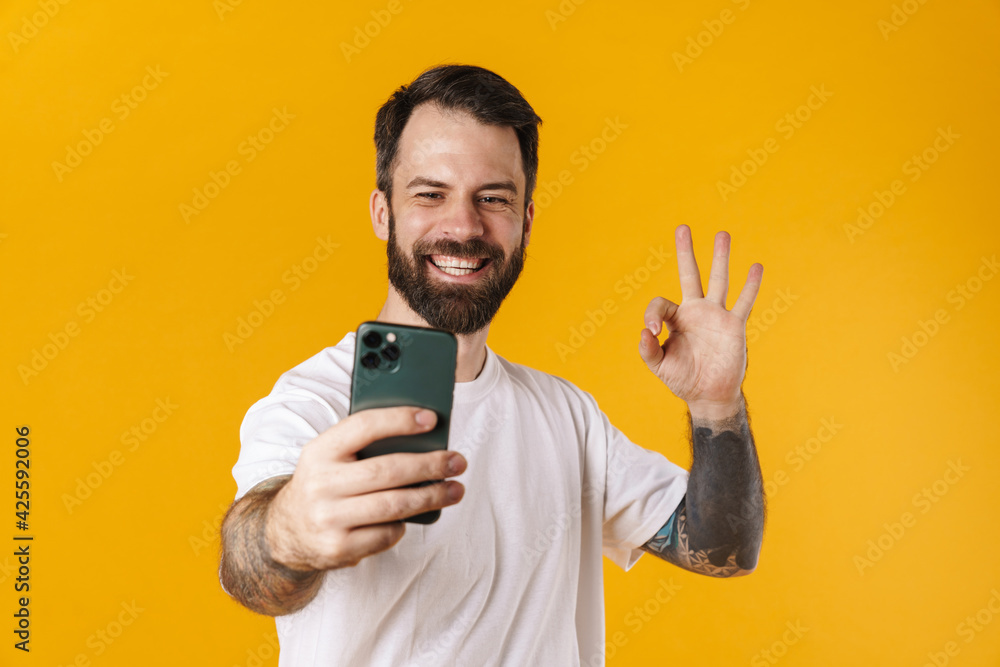 Happy mid aged brunette bearded man taking a selfie Happy mid aged brunette bearded man taking a selfie