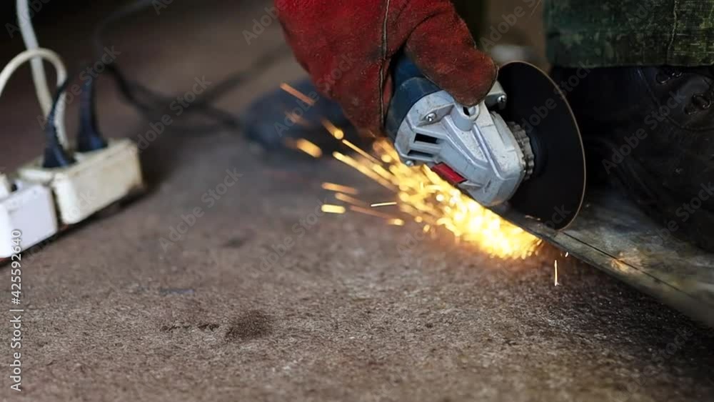 cutting a sheet of metal with a grinder flying sparks cutting a sheet of metal with a grinder flying sparks