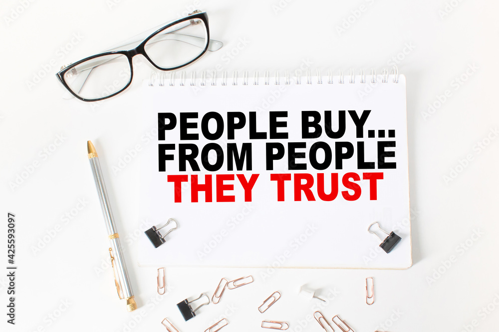Notepad with inscriptions PEOPLE BUY... FROM PEOPLE THEY TRUST on a white background. business concept. Notepad with inscriptions PEOPLE BUY... FROM PEOPLE THEY TRUST on a white background. business concept.