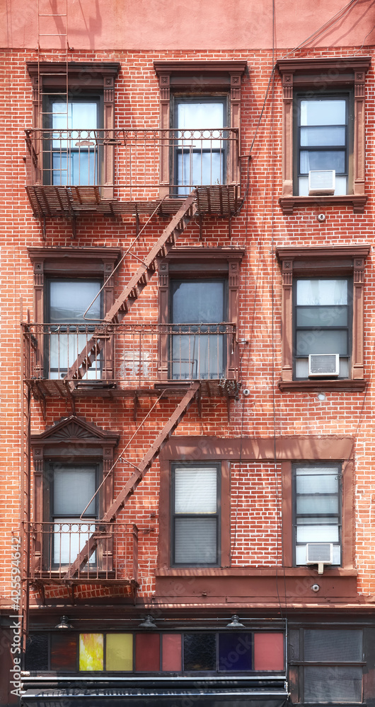 Old brick building with fire escape, New York City, USA.