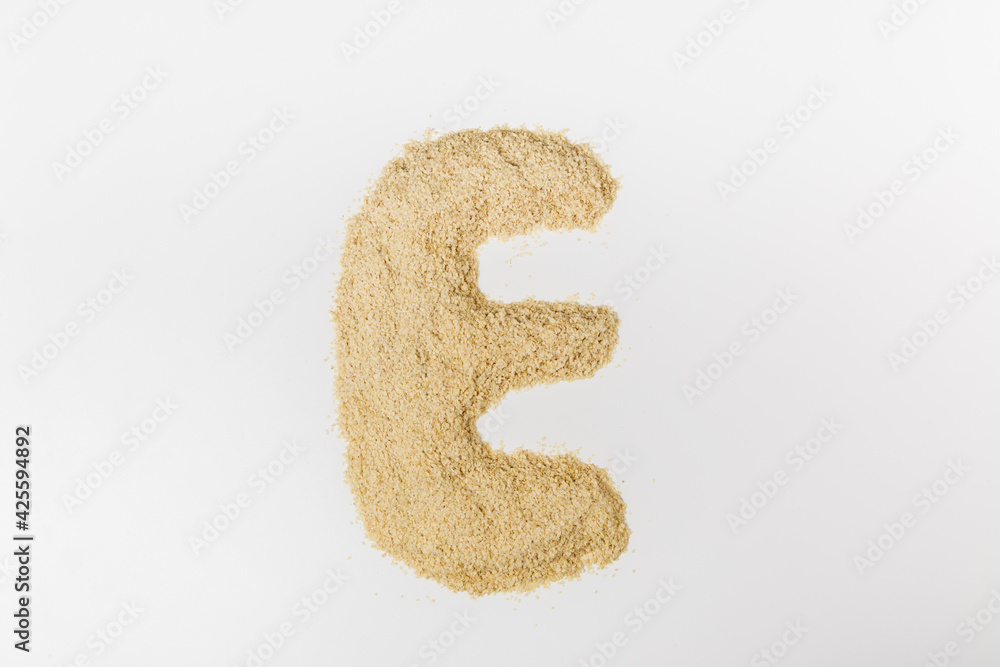 flat lay of wheat germ. letter E on the white background flat lay of wheat germ. letter E on the white background