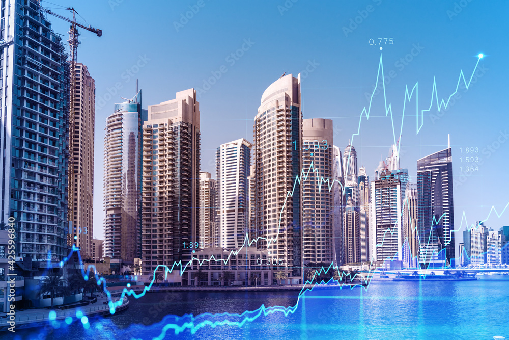 Fototapeta premium Skyscrapers of Dubai business downtown. International hub of trading and financial services of Western Asia. FOREX graph and chart concept. Double exposure. Dubai Canal waterfront.