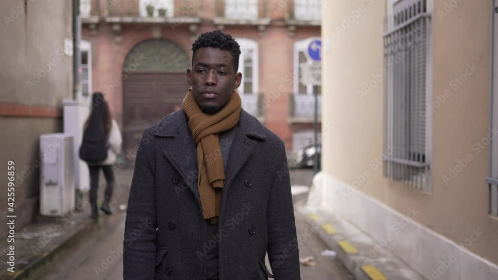 Moody pensive black african man walking in city Moody pensive black african man walking in city
