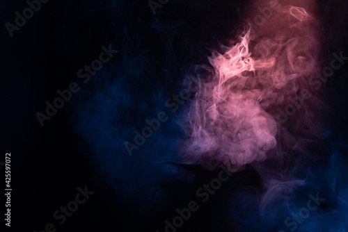 Blue and pink steam on a black background. © Nikolay