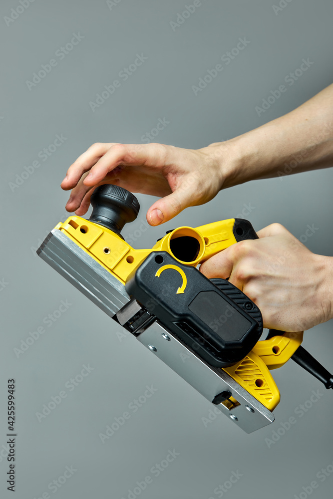 Carpenter hands turn on electric planer jointer Stock Photo Adobe Stock