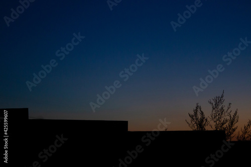 silhouette of the fence against the evening sky. Free copy space