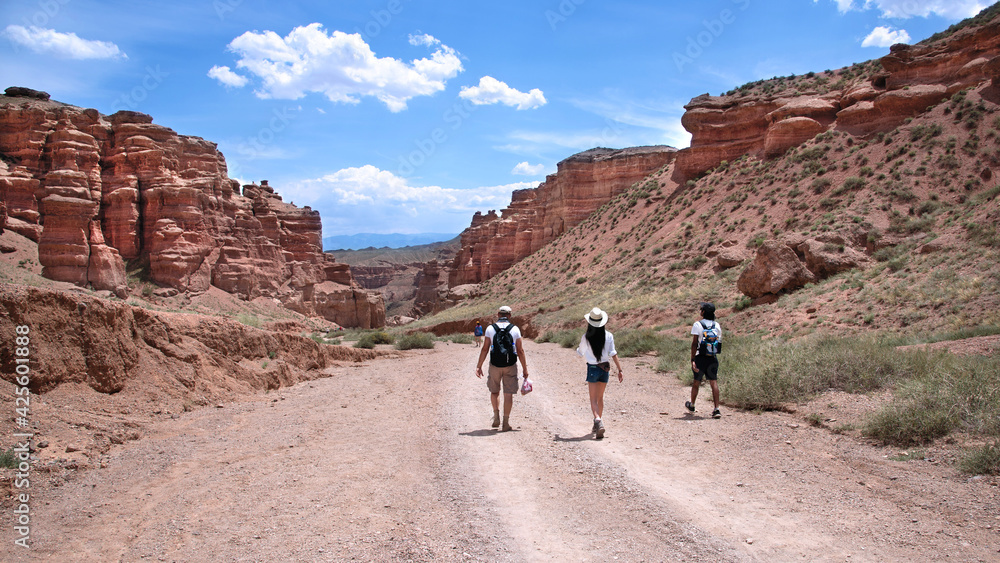 Beautiful landscape overlooking the canyon in the highlands of Charyn Canyon in Kazakhstan, group of tourists walking on the road