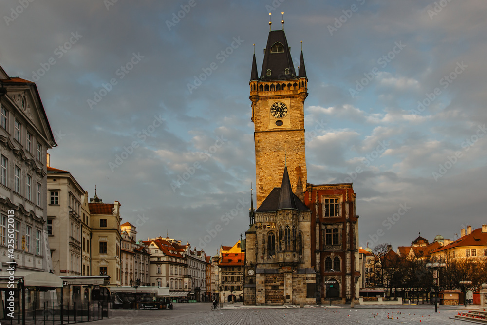 Old Town Square in Prague, Czech Republic. Empty city during sunrise without people surrounded by historical, gothic style buildings and the famous Astronomical Clock Tower.Beautiful urban scene