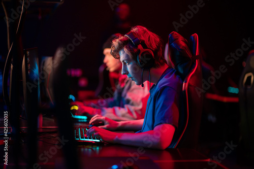 Professional esports players at an online game tournament. The cyber team plays computers and trains photo