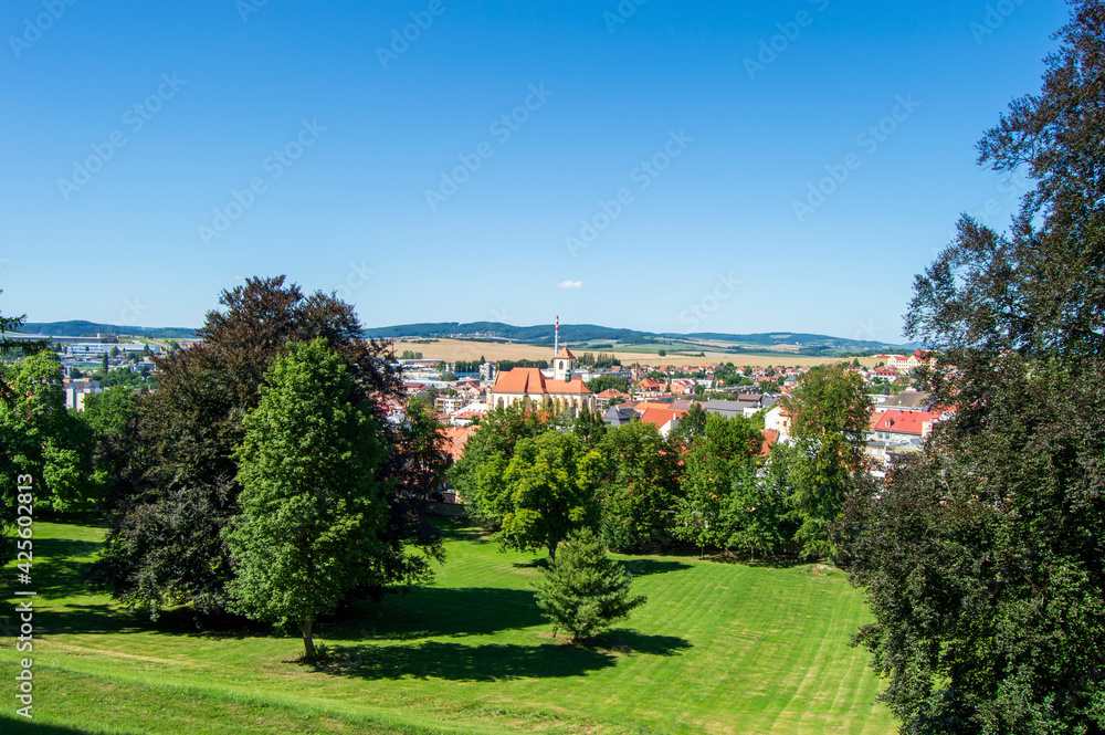 Landscape view near Boskovice castle ruins in Czech Republic. Blue sky, meadow, trees, red roofs of houses