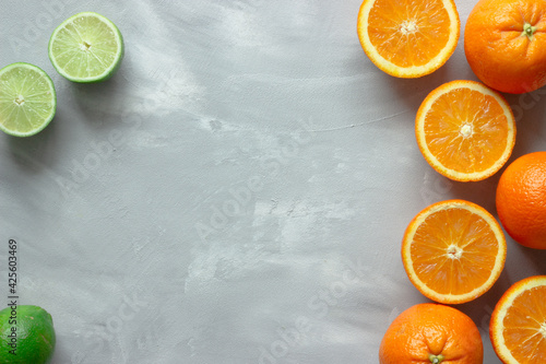 Colorful citrus fruits on gray background with copy space; vitamin C © Maria