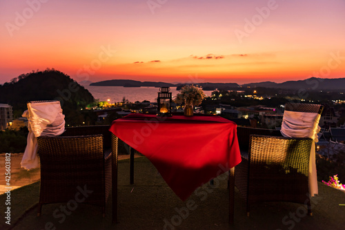 Outdoor dinner table with Krabi sea viiew at dusk photo