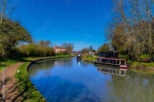 A view down the Oxford Canal towards the locks at Hillmorton, Warwickshire, UK on a bright Spring day