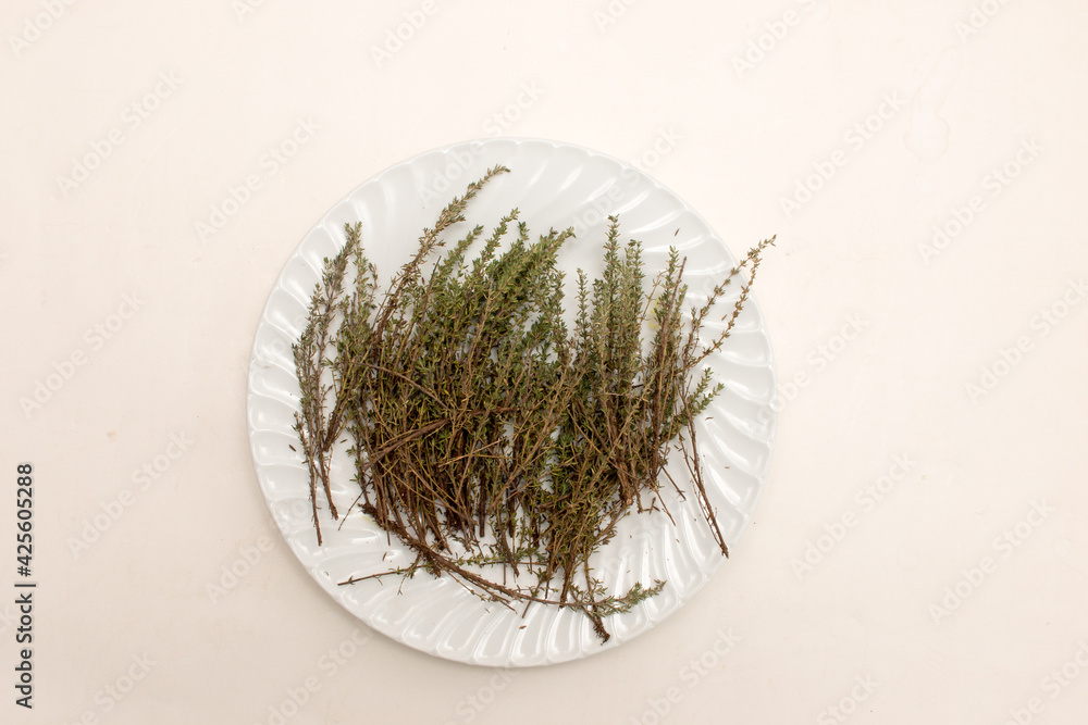 Fototapeta premium Fresh Thyme drying out on a white plate