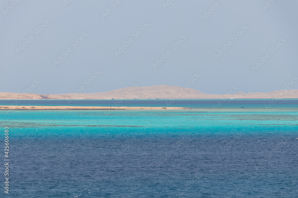 Fototapeta premium Seascape, panoramic view of the azure waters of the Red Sea, in the distance turquoise coral reefs, white desert sand on the horizon
