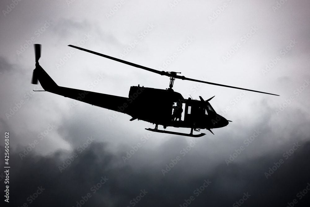 Untitled helicopter flying in the sky photo. Helicopter with no markings. Silhouette shot. Untitled helicopter flying in the sky photo. Helicopter with no markings. Silhouette shot.