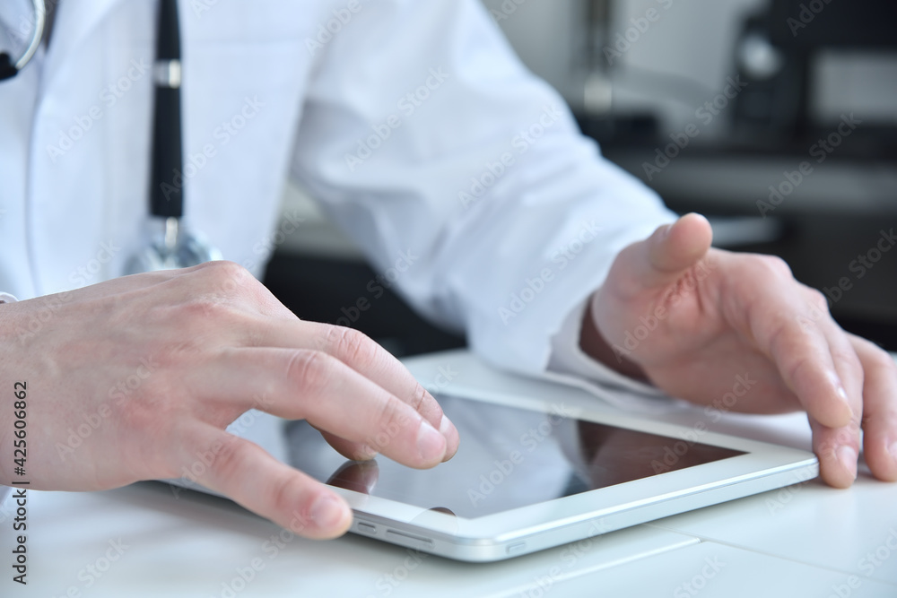 Doctor working on a digital tablet pc.