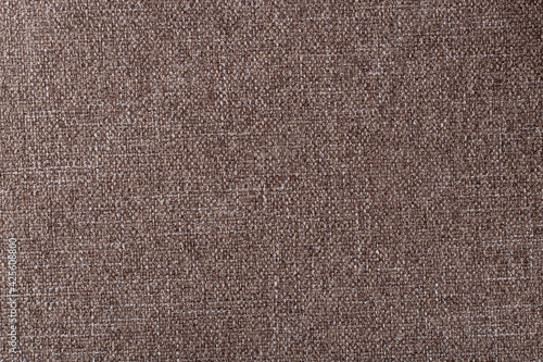 smooth surface of dense coffee-colored upholstery fabric with linen texture, background