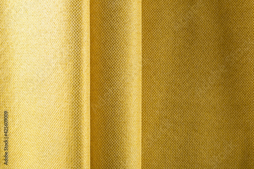 dense lemon-colored upholstery fabric, pleated drape, background