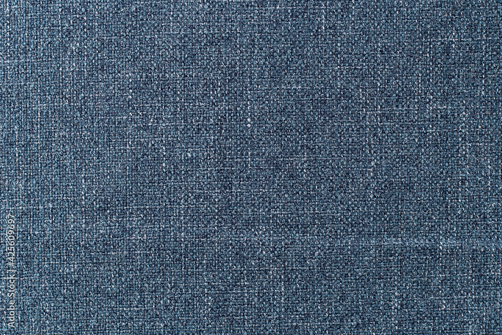 surface of dense upholstery fabric of pale blue color with linen texture, background surface of dense upholstery fabric of pale blue color with linen texture, background