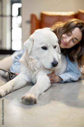Fototapeta Naklejka Na Ścianę i Meble -  Happy woman with a dog at home