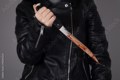 Caucasian killer bloody knife in hand. Crime concept.