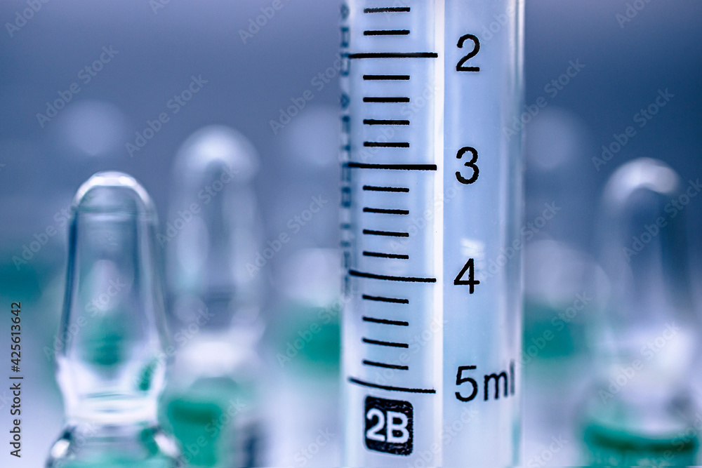 Syringe close-up and ampoules with virus vaccine Syringe close-up and ampoules with virus vaccine