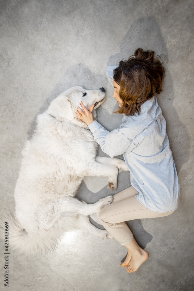 Woman with her dog lying together Woman with her dog lying together
