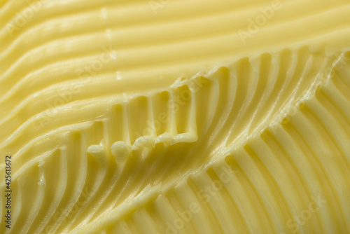 Butter close up with grooves and flicks creates textured background.