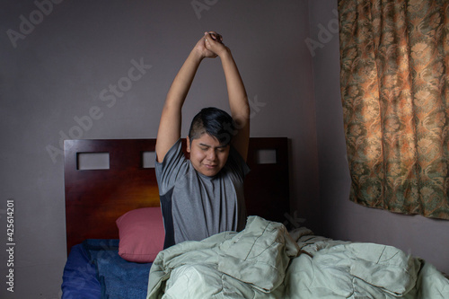 Mexican teen waking up in the morning in her bed, hispanic men