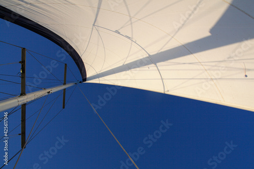 Concept of freedom. Beautiful white sail with blue clean sky on background