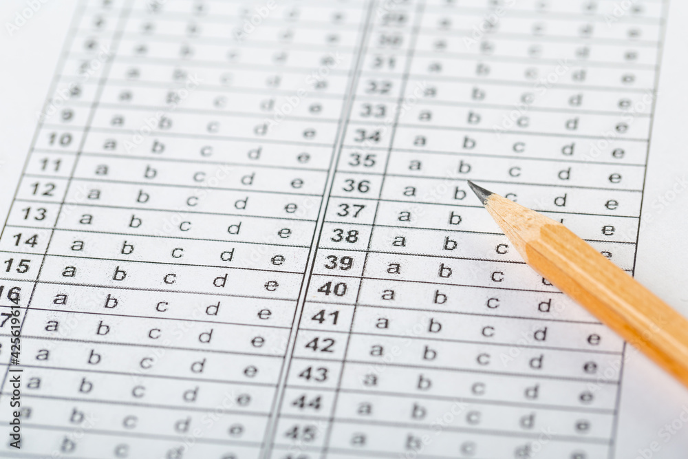testing in exercise and exam paper. computer sheet with pencil in school test room, education concept. filling in answers in pencil testing in exercise and exam paper. computer sheet with pencil in school test room, education concept. filling in answers in pencil